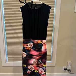 Beautiful dress. Black silky flowy blouse with tight floral skirt.